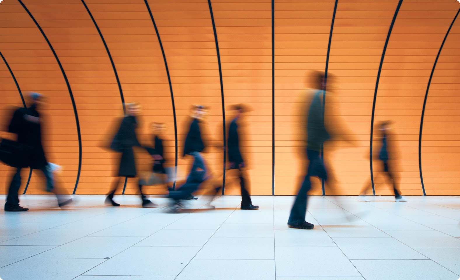People walking through an underground tunnel.